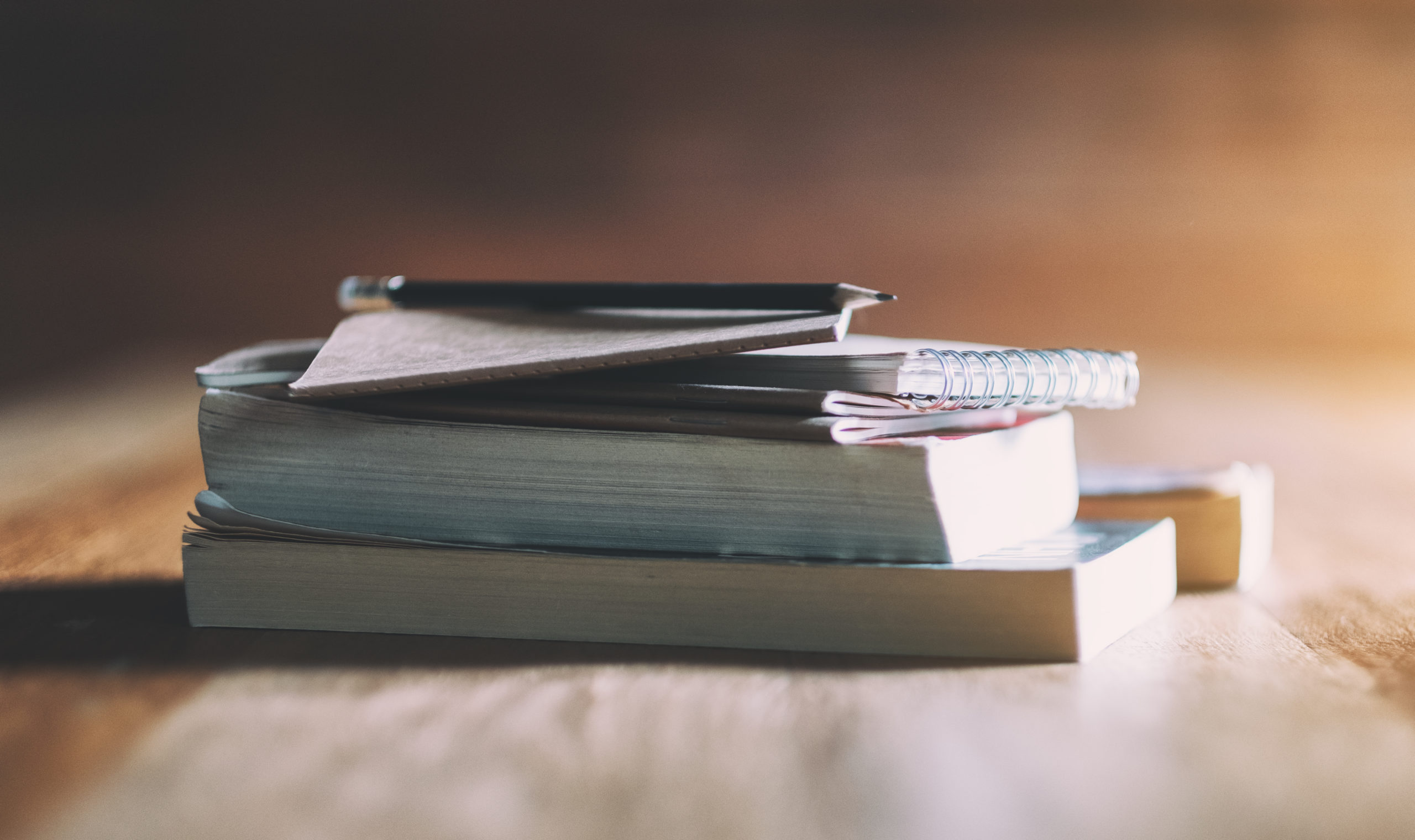 Books and notebooks on wooden table